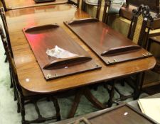 A reproduction mahogany rounded rectangular extending dining table with top with reeded edge and