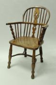 A 19th Century ash and elm low stick back elbow chair in the manner of Nicholson of Rockley on