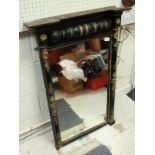 A 19th Century wall mirror with ebonised frame and gilt foliate decoration