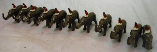 A collection of eleven circa 1930 painted lead figures of elephants and mahout stamped "made in