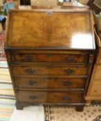 A 20th Century walnut bureau of four long drawers