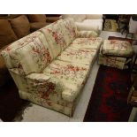 A three seat sofa with Colefax and Fowler fabric upholstery raised on block feet together with