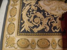 A modern Aubusson style rug with Classical motifs on a black and cream ground,