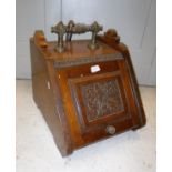 A late Victorian walnut coal box with floral panel decoration in the Aesthetic taste,