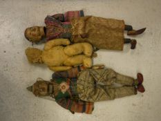 Two vintage Thai carved and painted wooden headed puppets with silver wire decorated clothing,