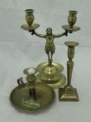 An 18th Century brass figural twin branch candlestick on a stepped base with drip tray together