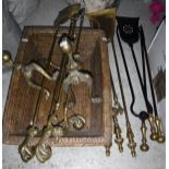 A modern brass three piece fire iron set with claw and ball handles,