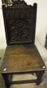 A set of three 19th Century carved oak panel seated hall chairs the backs decorated with flowers in