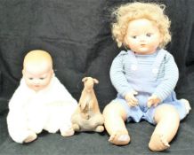 A box containing Armand Marseille baby doll, a composition doll,