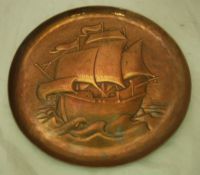 A Newlyn beaten copper plate decorated with a galleon stamped "Newlyn"