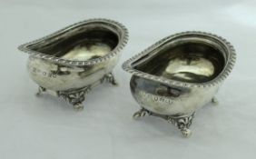 A pair of George IV silver open salts of rounded rectangular form with gadrooned rims raised on