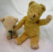 A Chad Valley polar bear cub together with a gold plush bear with jointed arms and legs bearing