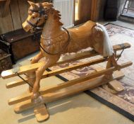 A modern carved pine rocking horse