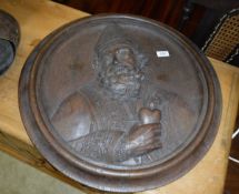 A 19th Century carved oak panel depicting St, Augustine,