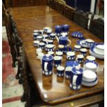 A Modern figured mahogany veneered extending dining table, the cross banded top with moulded edge,