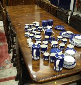 A Modern figured mahogany veneered extending dining table, the cross banded top with moulded edge,