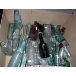 A box containing a quantity of various old lemonade and other bottles