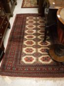 A Belouch rug, the central panel set with repeating medallions on a cream ground,