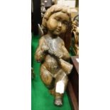 A 17th / early 18th Century Continental carved wooden figure of a putto with horn