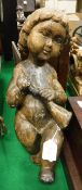 A 17th / early 18th Century Continental carved wooden figure of a putto with horn