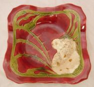 A Minton secessionist square dish decorated with a wild rose on a red ground CONDITION