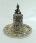 A silver plated table bell in the neo-Classical manner, decorated with cherubs and figures,
