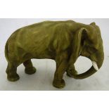 A Royal Dux style elephant figure with gilt on green decoration,