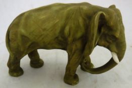 A Royal Dux style elephant figure with gilt on green decoration,