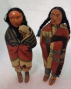 A wood wool filled doll as a native American with child in papoose and wrapped in a blanket,