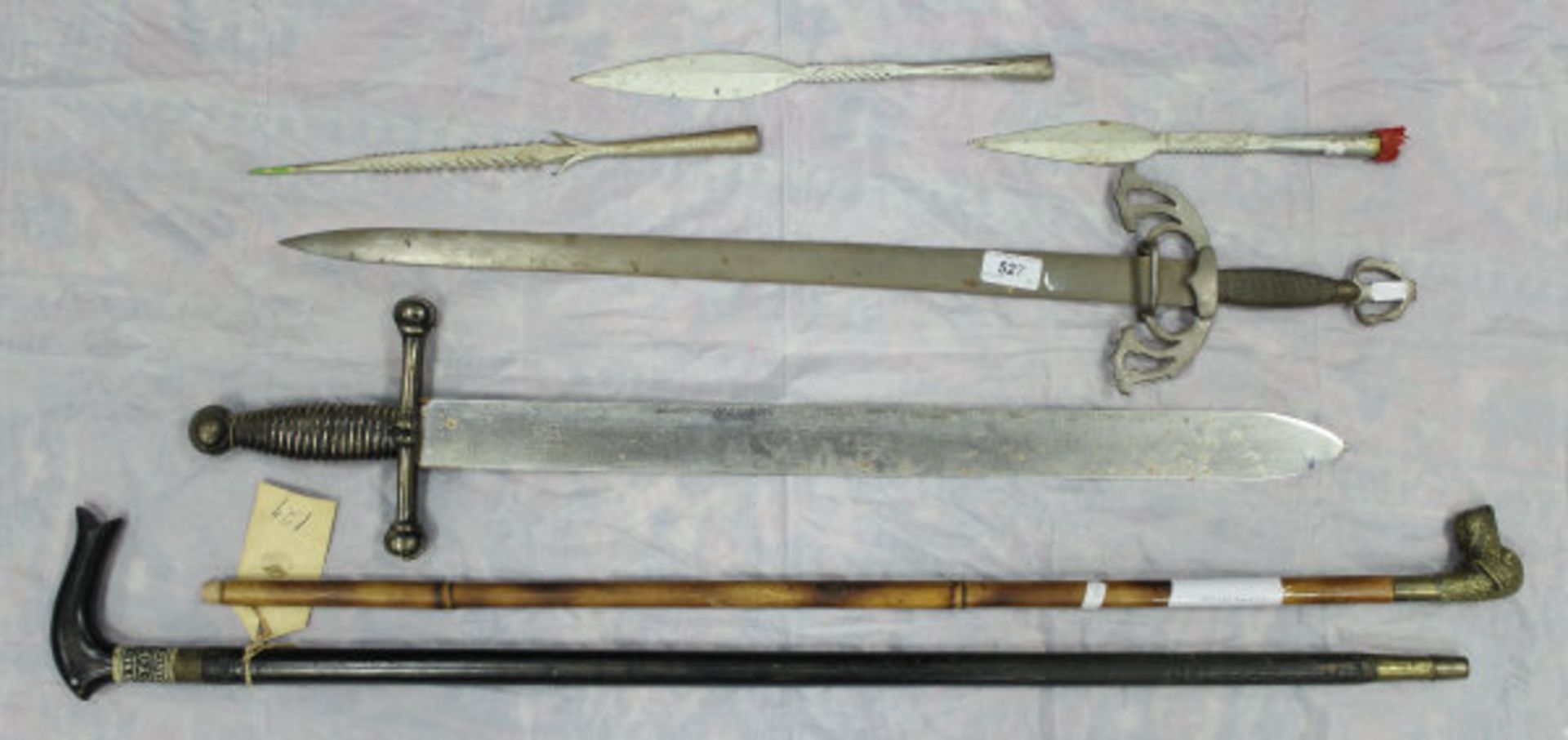 Two modern gladius type swords and three fishing spear heads together with two early 20th Century