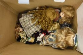 A box of seven modern bisque headed dolls