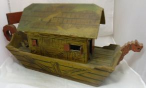 An early 20th Century painted wooden Noah's ark with rising roof section revealing a recess,