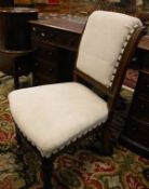 A set of four Victorian oak scroll back upholstered dining chairs on carved and fluted tapering