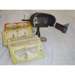 A hand-held wooden stereoscope and a quantity of slides,