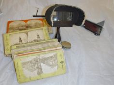 A hand-held wooden stereoscope and a quantity of slides,
