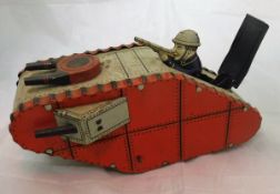 A circa 1930 tinplate model of a world war I tank clockwork with pop up gunner inscribed "made in