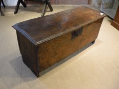 An 18th Century oak hutch or six plank coffer of plan form on V cut end supports