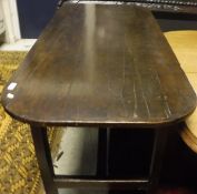 A 19th Century oak tavern type table the rounded rectangular plank top with cleated ends on square