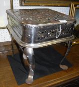 A 19th Century pierced steel trivet on cabriole front legs to pad feet