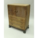 An oak chest of three short over one long drawer and an oak tallboy with two cupboard doors above