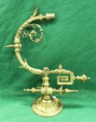 A pair of 19th Century cast gilt brass adjustable wall lights in the rococo taste