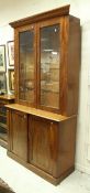 A Victorian mahogany bookcase cabinet with two glazed doors over two cupboard doors