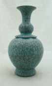 A Chinese speckled turquoise glazed vase of gourd form with studded panelled shoulders and flaired