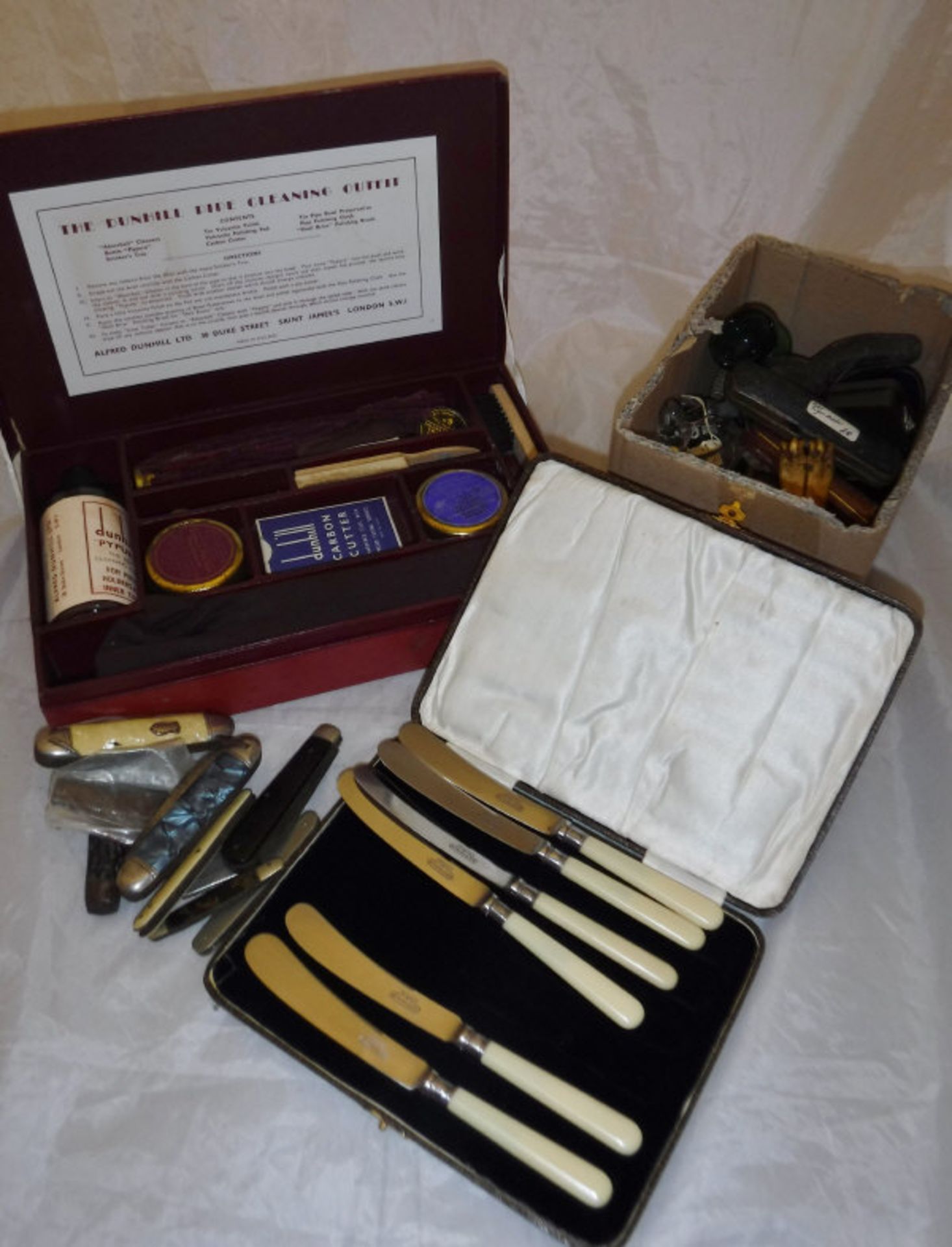 A box of various Meerschaum pipes, cigar and cigarette holders, knucklebone apple corer,