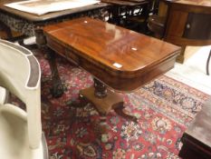 A Victorian mahogany fold over card table on centre pedestalled quadraped base