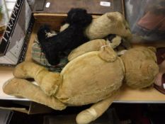 An early 20th Century gold plush wood wool filled bear with growler,