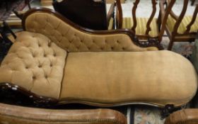 A Victorian mahogany show framed chaise longue with button back upholstery