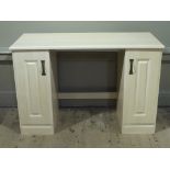 A reproduction knee hole dressing table with pair of fielded panelled doors,