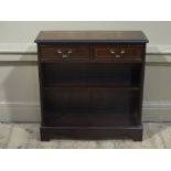 A reproduction mahogany finished set of bookshelves with two drawers