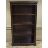 A reproduction mahogany bookcase in Georgian style fitted with three adjustable shelves,